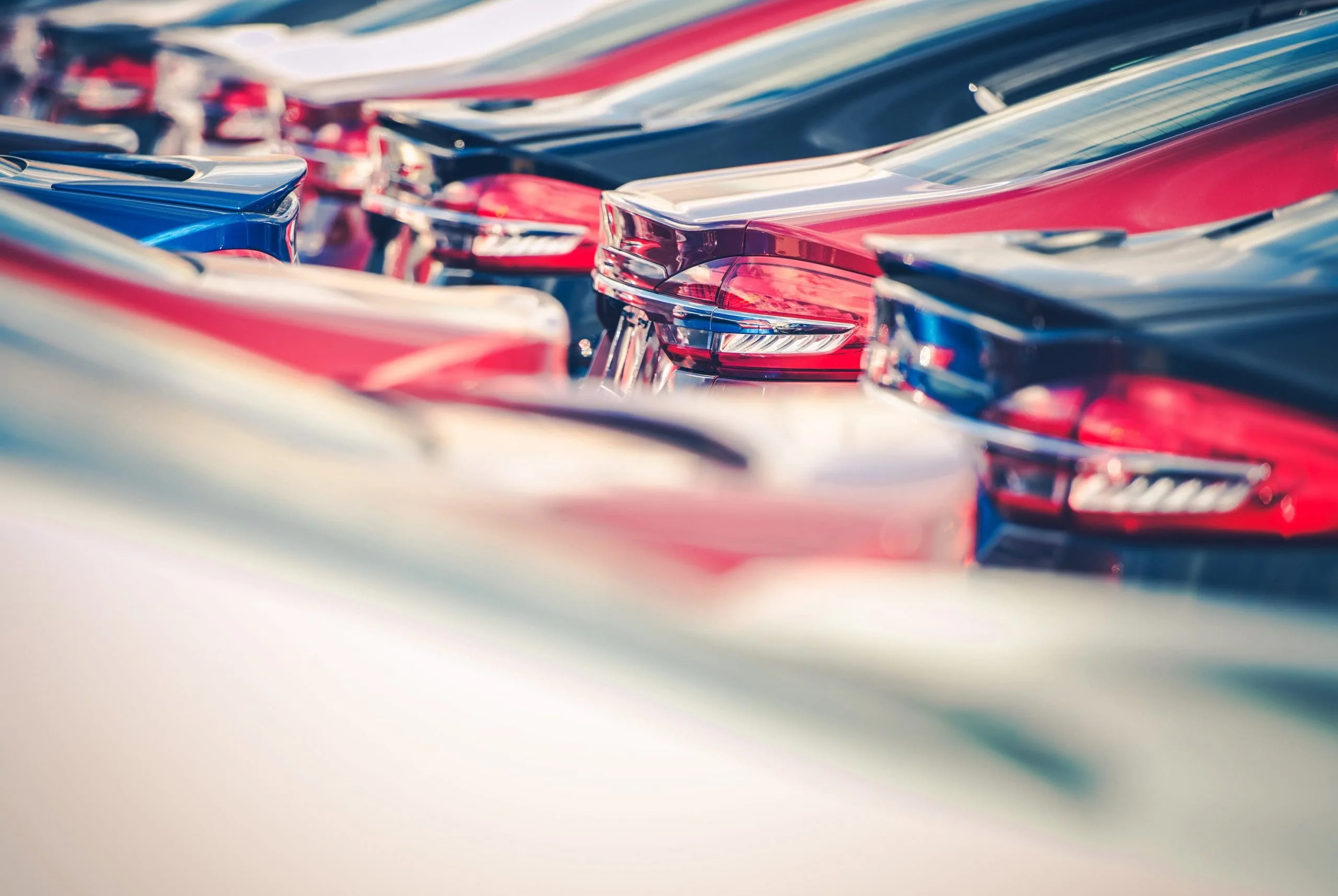 Fleet of parked cars protected by company auto insurance