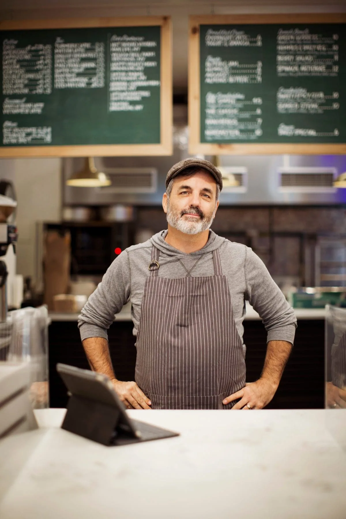 Portrait of confident male owner with tablet computer on shop counter Portrait of confident male owner with tablet computer on shop counter