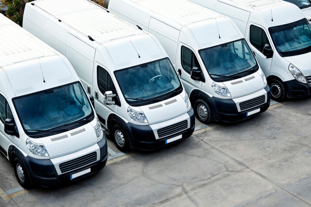 A fleet of commercially insured transit vans is shown from above.